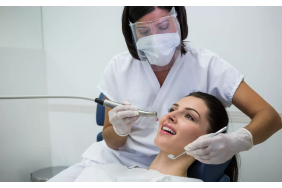 dentist-examining-female-patient-with-tools-copy-1920x1200