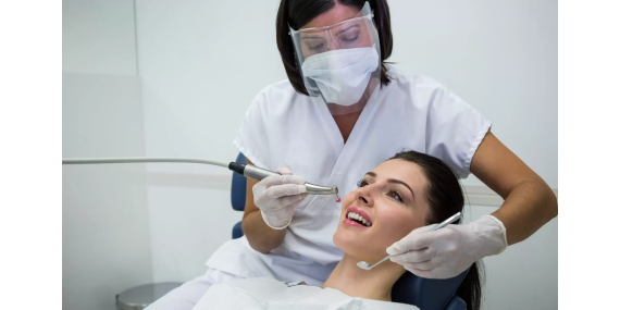 dentist-examining-female-patient-with-tools-copy-1920x1200