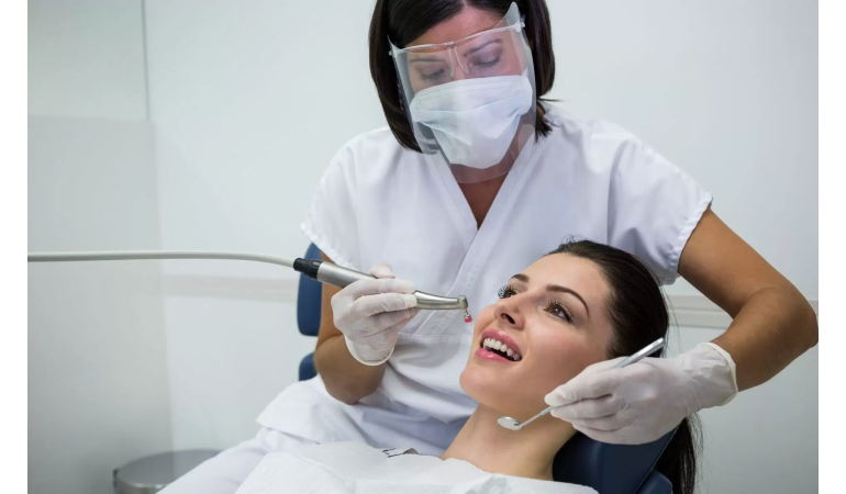 dentist-examining-female-patient-with-tools-copy-1920x1200